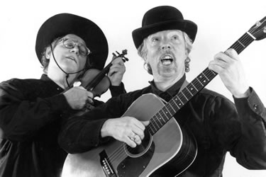 balck and white photo of Horowitz and Malkine singing and playing instruments
