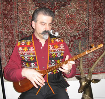 musician in embroidered vest playing instrument